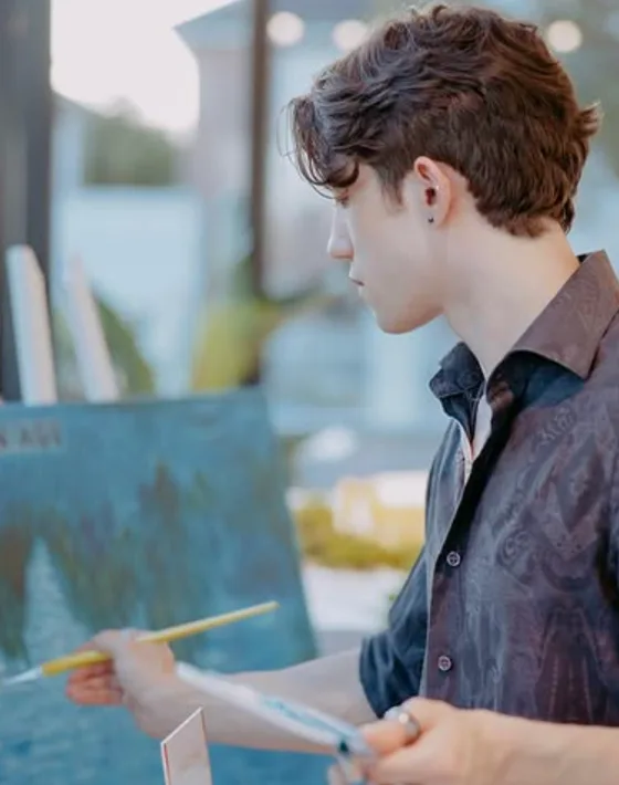 Dan, the artist and instructor, painting a moonlit scene at an easel outdoors