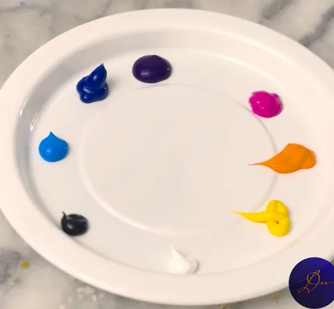 Module 1: the eight acrylic colors squeezed around the rim of a plain plastic plate, cool colors on one side and warm colors on the other