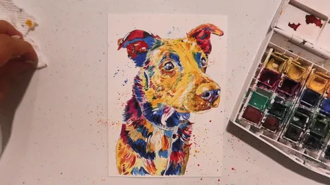 Module 5: a finished rainbow watercolor dog portrait with a splatter background, beside a well-used palette