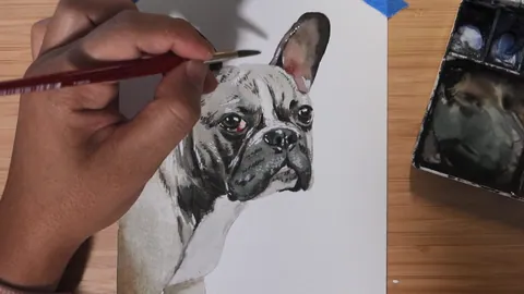 Painting the eyes, nose and fur details of a dog portrait